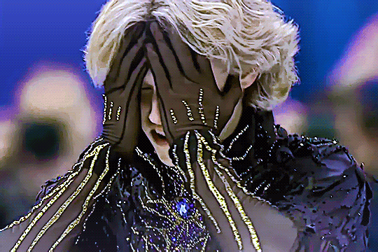 ilia malinin after his olympics 2026 individual free skate, looking extremely distressed and moving his hands from covering his face to running them through his hair