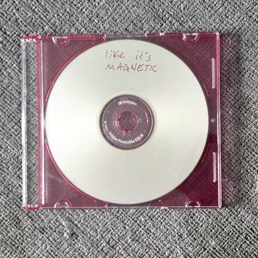 my physical burned CD for this mix in a slim translucent hot pink jewel case, the case is closed and photo is taken from the front, there is no printed cover for the mix