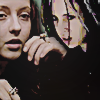 composite icon of two shots of brigitte and ginger. ginger has her arms up as if about to make fists and fight, while brigitte eyes ginger warily and darkly