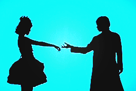two berryz members in silhouette doing suggestive poses, one in feminine clothes and the other more masculine