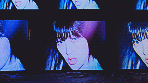 ARTMS virtual angel music video shot of several CRT TVs stacked upon each other, one in focus, all playing the same video of choerry singing