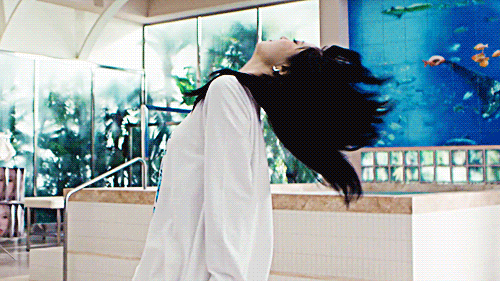 eunchae in the le sserafim crazy music video doing a spin death drop kinda movement thing on the floor