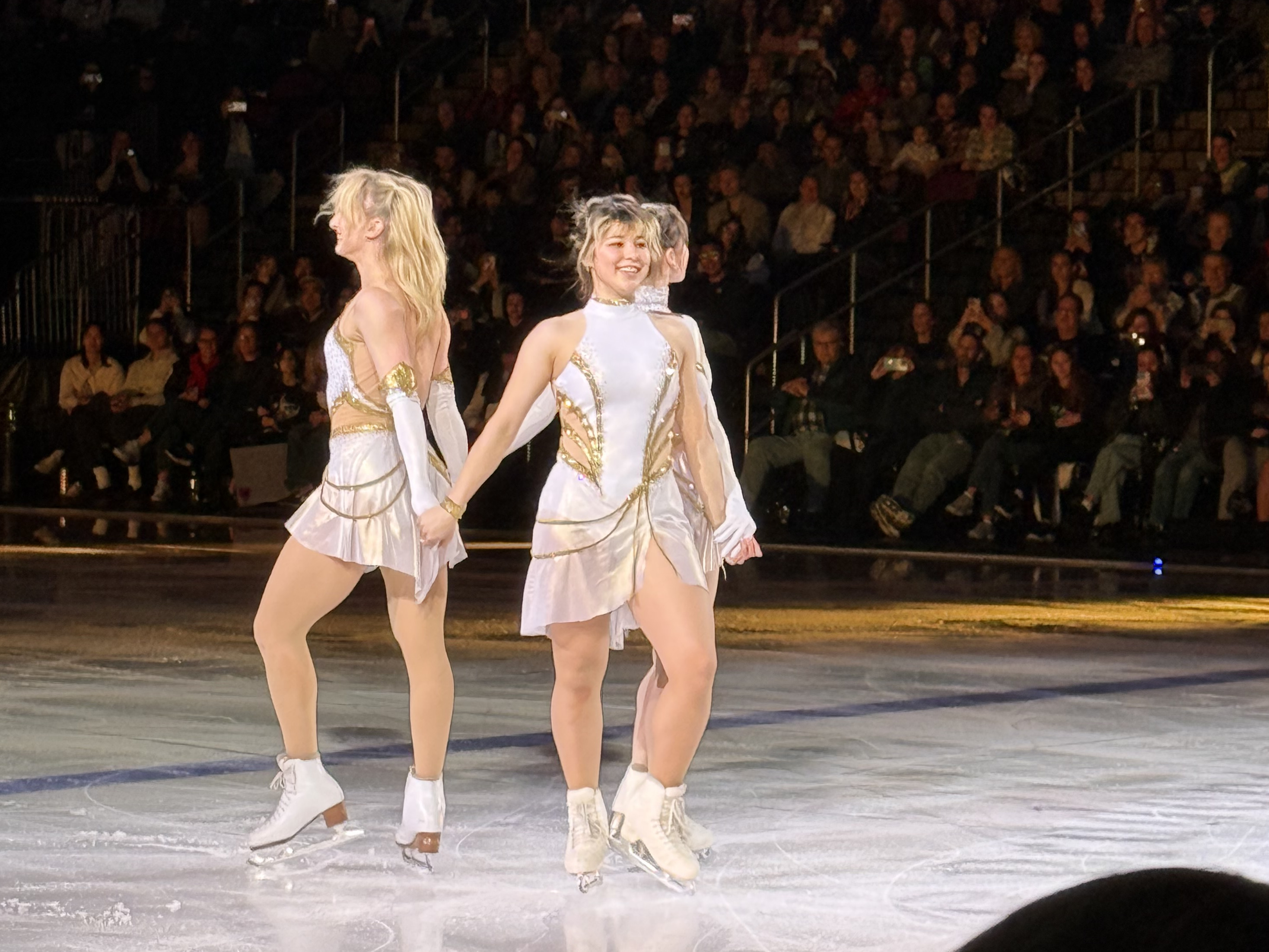 alysa liu, amber glenn, and isabeau levito posing together at the end of their 'golden' routine at stars on ice 2026 newark show