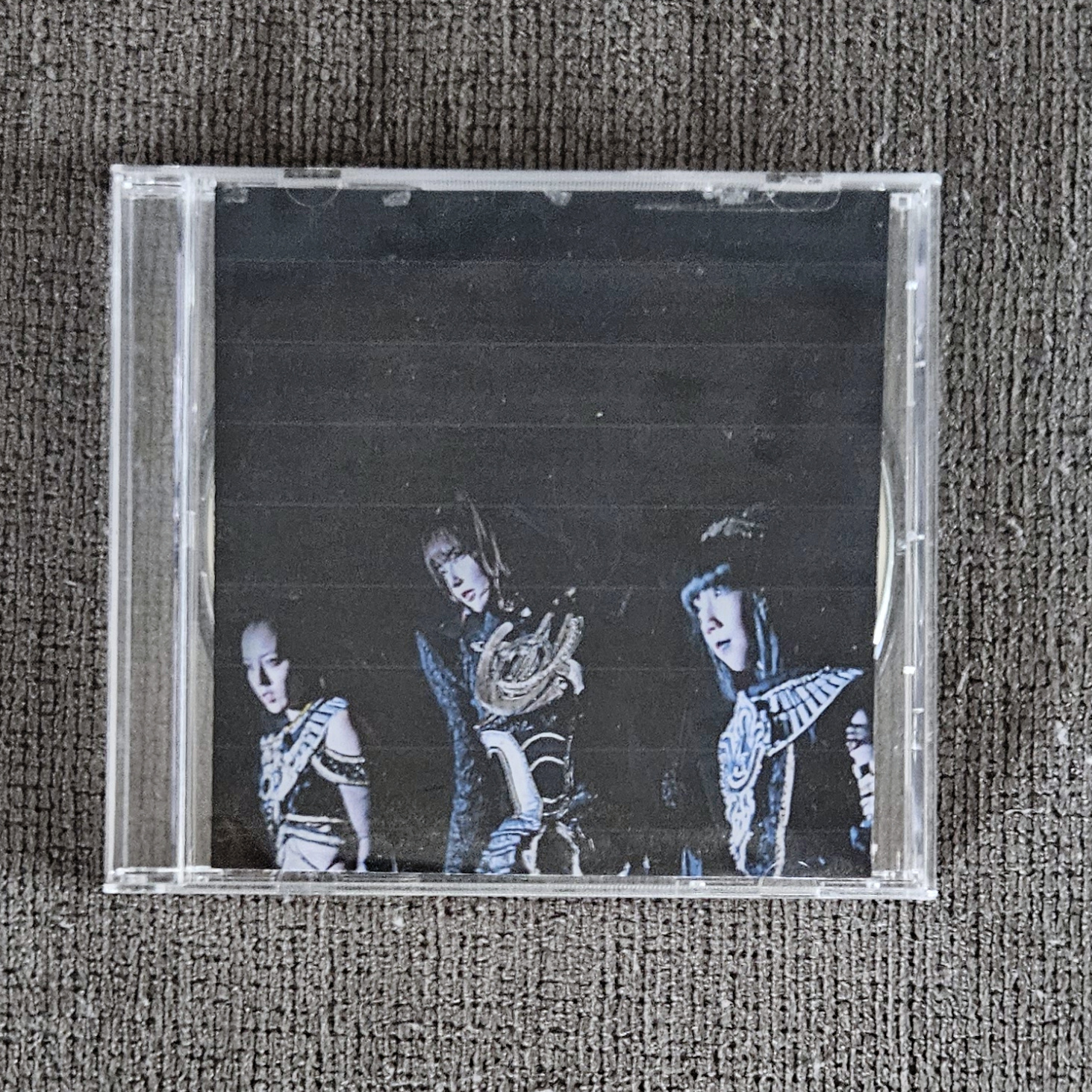 my physical burned CD for this mix in a jewel case, the case is closed and photo is taken from the front showing the previously described cover art