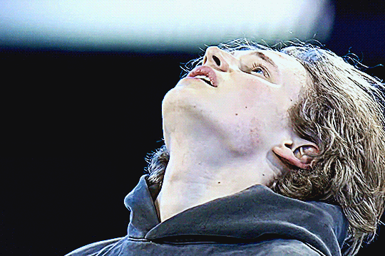 ilia after the gala skate, breathing heavily with his head tilted upward, swallowing and seeming emotional