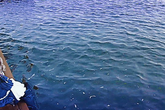 GIF of lizel in kamen rider gavv sitting at the ledge before a river looking very sad